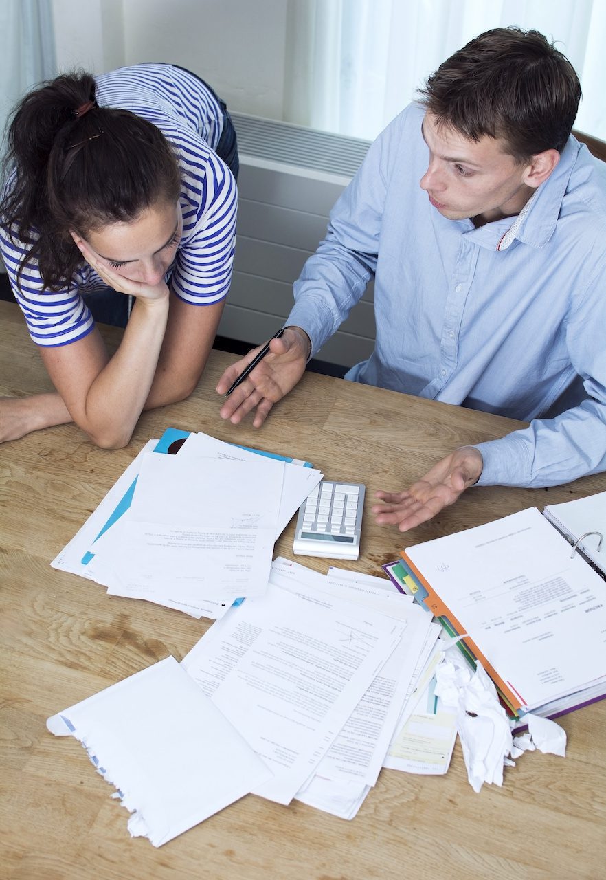 man and woman discussing bad financial situation Cost-Burdened Household